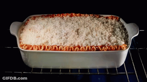A Casserole Dish Filled With Macaroni And Cheese Is Being Cooked In An Oven GIF