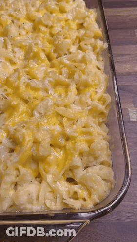 A Casserole Dish Filled With Macaroni And Cheese GIF