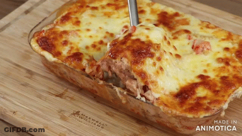 A Casserole Dish With A Spoon In It Is Made By Maxwell Williams GIF