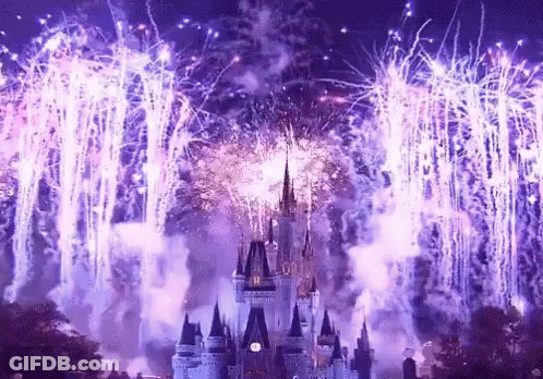A Castle Is Surrounded By Purple Fireworks And Smoke GIF