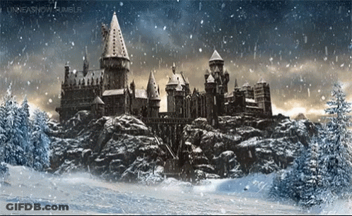 A Castle Is Surrounded By Snow Covered Trees And Rocks GIF