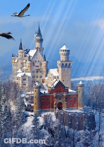 A Castle Surrounded By Snow And Trees With Birds Flying Overhead GIF