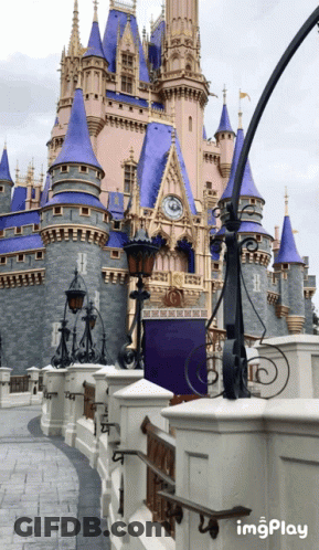 A Castle With A Clock On The Top Of It And A Sign That Says Imgplay GIF
