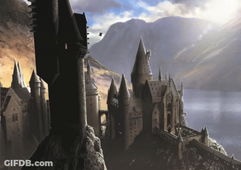 A Castle With A Mountain In The Background And A Few Birds Flying Around GIF