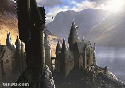 A Castle With A Mountain In The Background And Birds Flying Around GIF