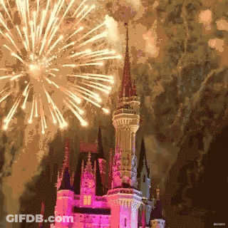 A Castle With Fireworks In The Background And Disney Written On The Bottom GIF
