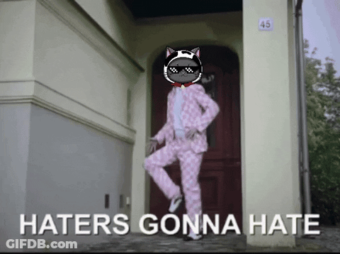 A Cat In A Pink Suit Is Dancing In Front Of A Door With The Words Haters Gonna Hate Below It GIF