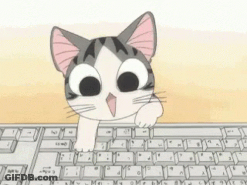 A Cat Is Peeking Over A Computer Keyboard GIF