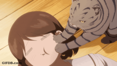 A Cat Is Petting A Woman 'S Ear While Laying On A Wooden Floor GIF