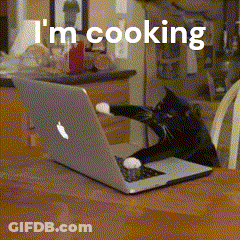 A Cat Is Reaching For A Laptop That Says I 'M Cooking On It GIF