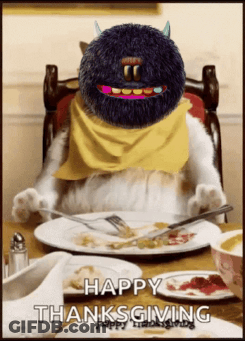 A Cat Is Sitting At A Table With A Plate Of Food And A Happy Thanksgiving Greeting GIF