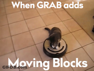 A Cat Is Sitting On Top Of A Robotic Vacuum Cleaner GIF