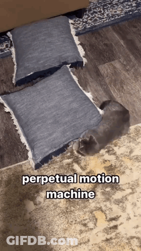 A Cat Laying Under A Pile Of Pillows With The Words Perpetual Motion Machine Above It GIF