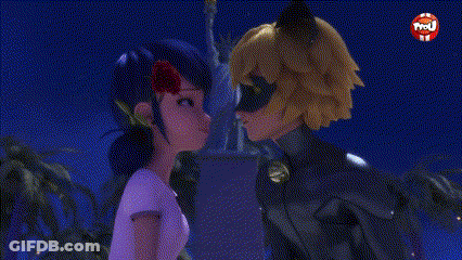 A Cat Noir And A Ladybug Are Kissing In Front Of A Statue Of Liberty . GIF