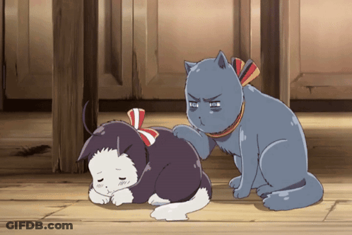 A Cat Scratching Another Cat 'S Back With A Red White And Blue Bow Around Its Neck GIF