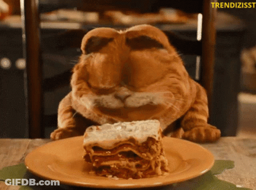 A Cat That Looks Like Garfield Is Eating A Slice Of Lasagna From A Plate GIF