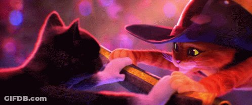 A Cat Wearing A Cowboy Hat Is Playing With Another Cat GIF