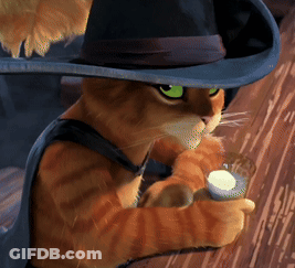 A Cat Wearing A Hat And A Cape Is Holding A Glass Of Milk GIF
