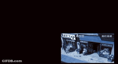 A Cctv Camera Shows A Man Wearing A Jacket That Says ' Bigshot Boys ' On It GIF