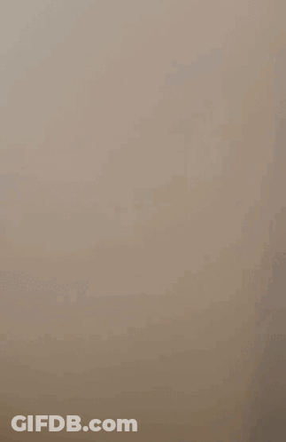 A Cell Phone Is Floating In The Air With A Picture Of A Person On The Screen . GIF