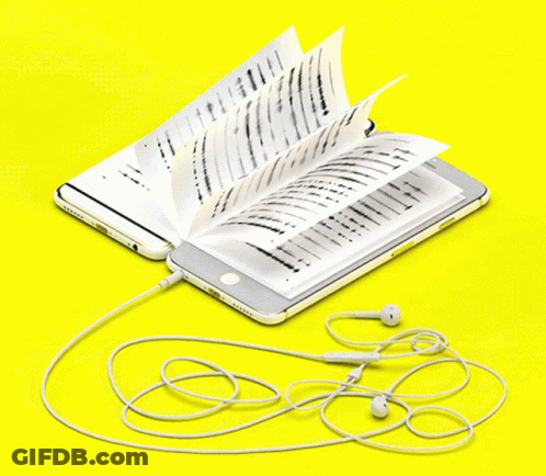 A Cell Phone Is Plugged Into An Open Book GIF