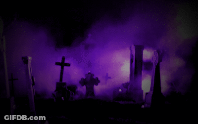 A Cemetery With A Purple Light Behind It GIF