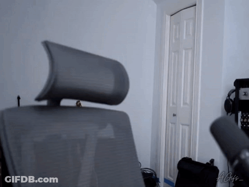 A Chair With A Headrest Is In A Room With A Microphone And A Sign That Says Agis GIF