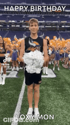 A Cheerleader Is Holding A Bunch Of Pom Poms On A Field . GIF