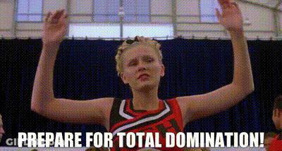A Cheerleader Is Holding Her Arms Up In The Air And Says `` Prepare For Total Domination ! '' GIF