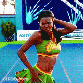 A Cheerleader Stands In Front Of A Sign That Says Nation On It GIF