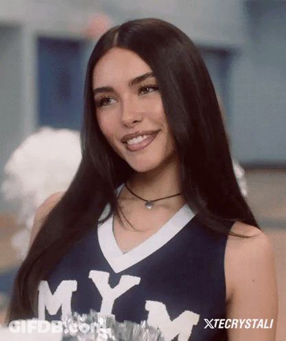 A Cheerleader Wearing A Mym Jersey Smiles For The Camera GIF