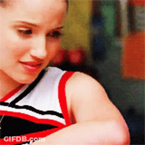 A Cheerleader Wearing A Red White And Black Outfit GIF
