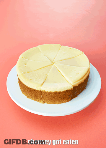 A Cheesecake With A Slice Taken Out Of It On A Plate GIF