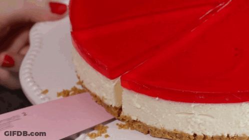 A Cheesecake With A Slice Taken Out Of It On A White Plate GIF