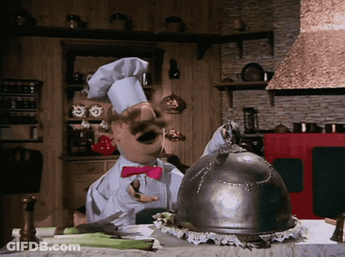 A Chef In A Kitchen With A Helmet On Top Of The Table GIF