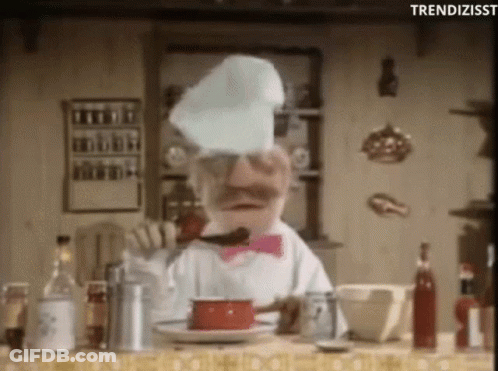 A Chef In A Pink Bow Tie Is Cooking In A Kitchen . GIF