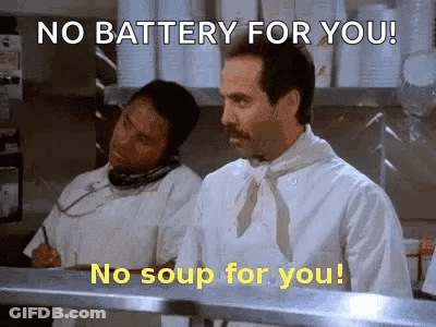 A Chef Is Talking On A Phone In A Kitchen While Another Chef Looks On . GIF