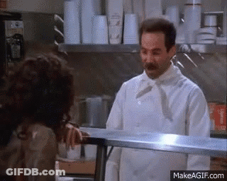 A Chef Is Talking To A Woman In A Kitchen . GIF