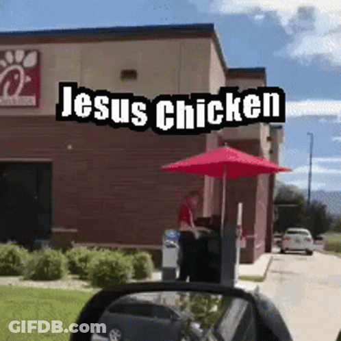A Chick Fil A Restaurant With Jesus Chicken Written On The Side Of It GIF
