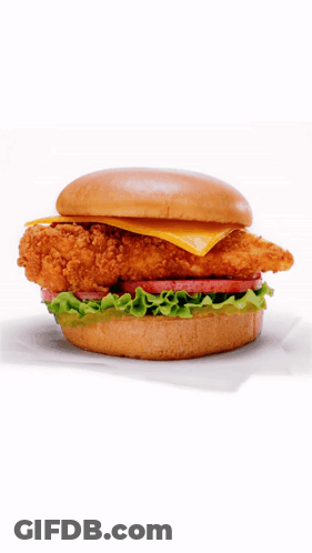 A Chicken Sandwich With Lettuce Tomato And Cheese GIF