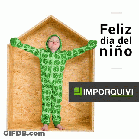 A Child In A Green Jumpsuit Is Standing In A Wooden Box With The Words Feliz Dia Del Niño Written Above Him GIF