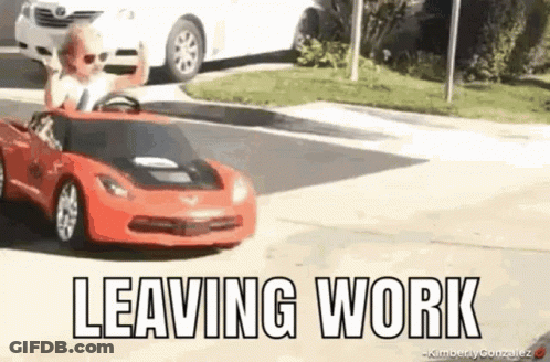 A Child Is Driving A Red Toy Car On A Street . GIF