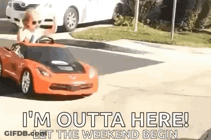 A Child Is Driving A Toy Car Down A Street . GIF