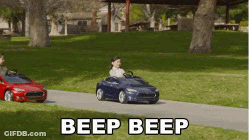 A Child Is Driving A Toy Car With The Words Beep Beep Written Below It GIF