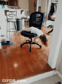 A Child Is Laying On A Chair In A Room GIF