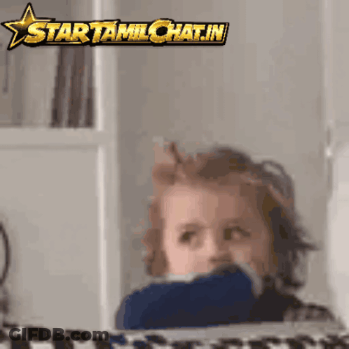 A Child Is Looking At The Camera With A Star That Says Starttamilchat.in On It GIF