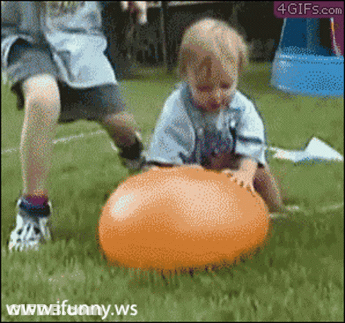 A Child Is Playing With An Orange Ball And The Website Www.ifunny.ws Is Visible In The Corner GIF