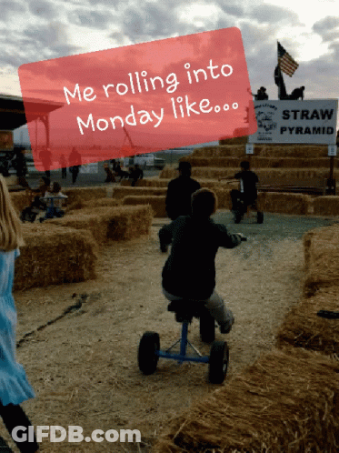A Child Is Riding A Tricycle In A Field With A Sign That Says Straw Pyramid GIF