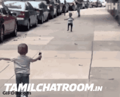 A Child Is Running Down A Sidewalk With The Words Tamilchatroom.in Written On The Bottom GIF