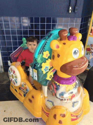 A Child Is Sitting On A Giraffe Rocker Toy GIF